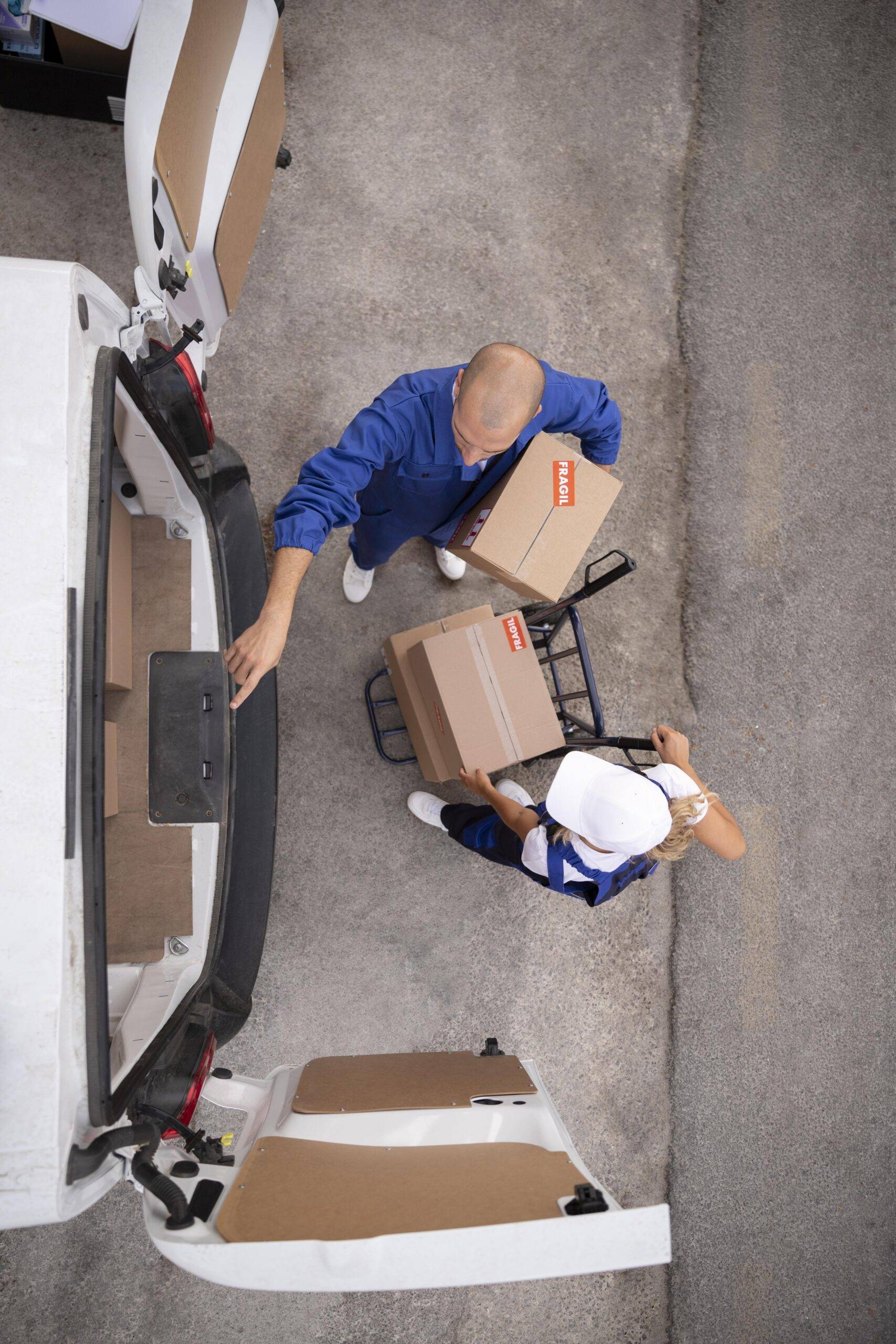 full-shot-delivery-people-holding-box | moving company in winnipeg