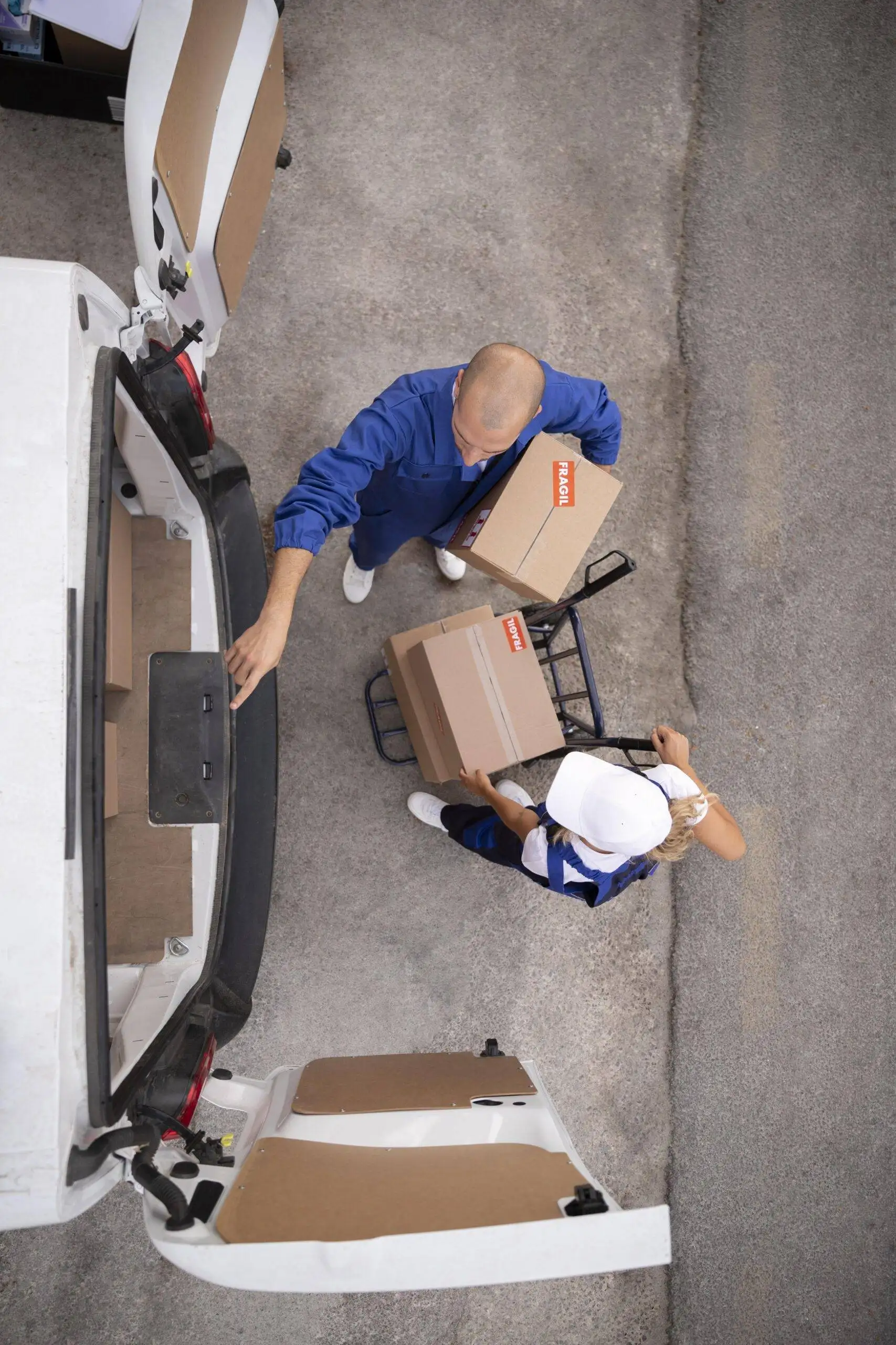 full-shot-delivery-people-holding-box | moving company in winnipeg